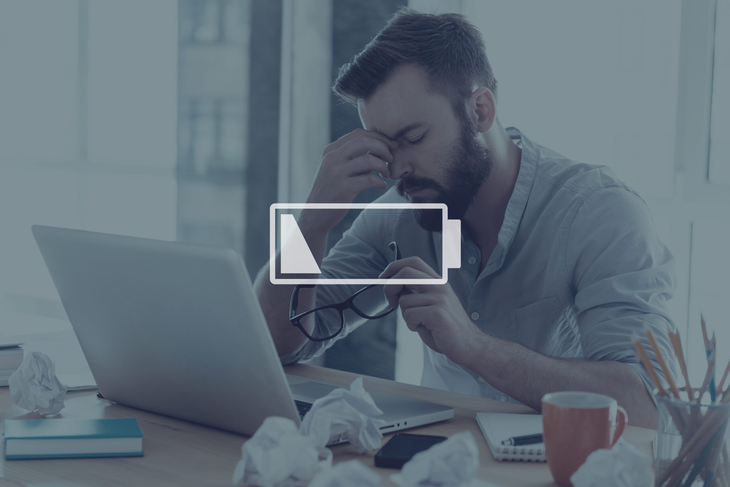 A low battery icon over a stressed man in the background.